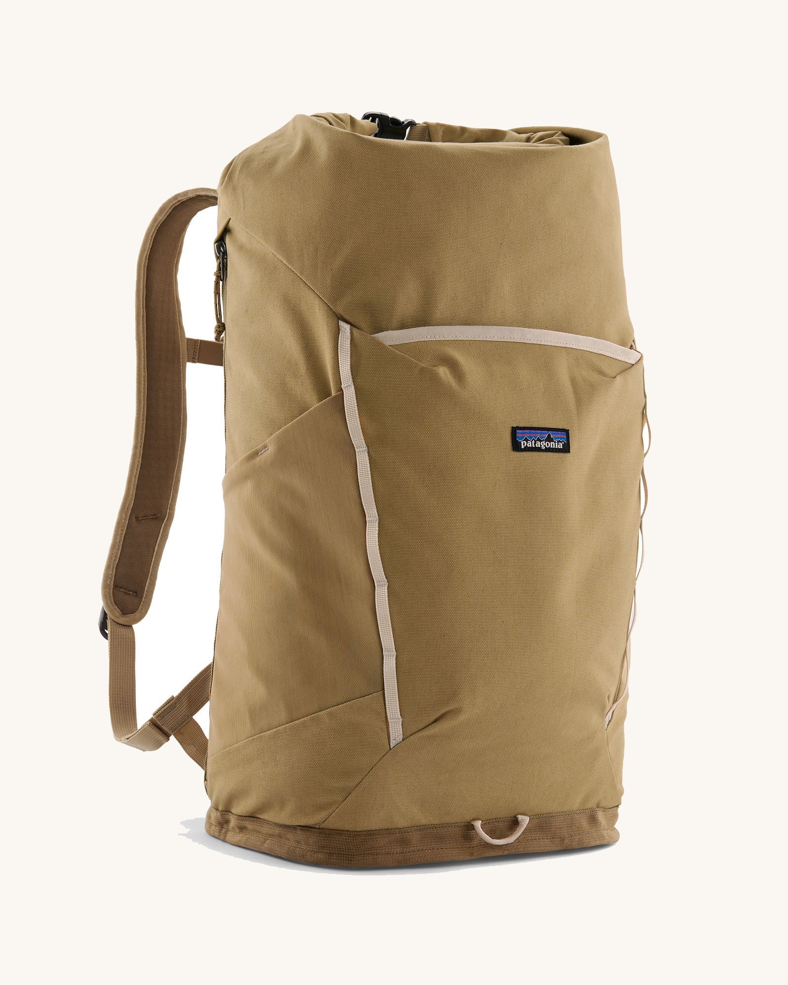 Patagonia fieldsmith roll top backpack in classic tan with zipped compartments and small blag logo tag on front.