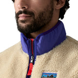 Close-up of a person wearing a Patagonia fleece vest with a visible brand logo.