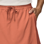 Patagonia women's fleetwith skort in a pastel orange colour worn by a woman front pocket detail