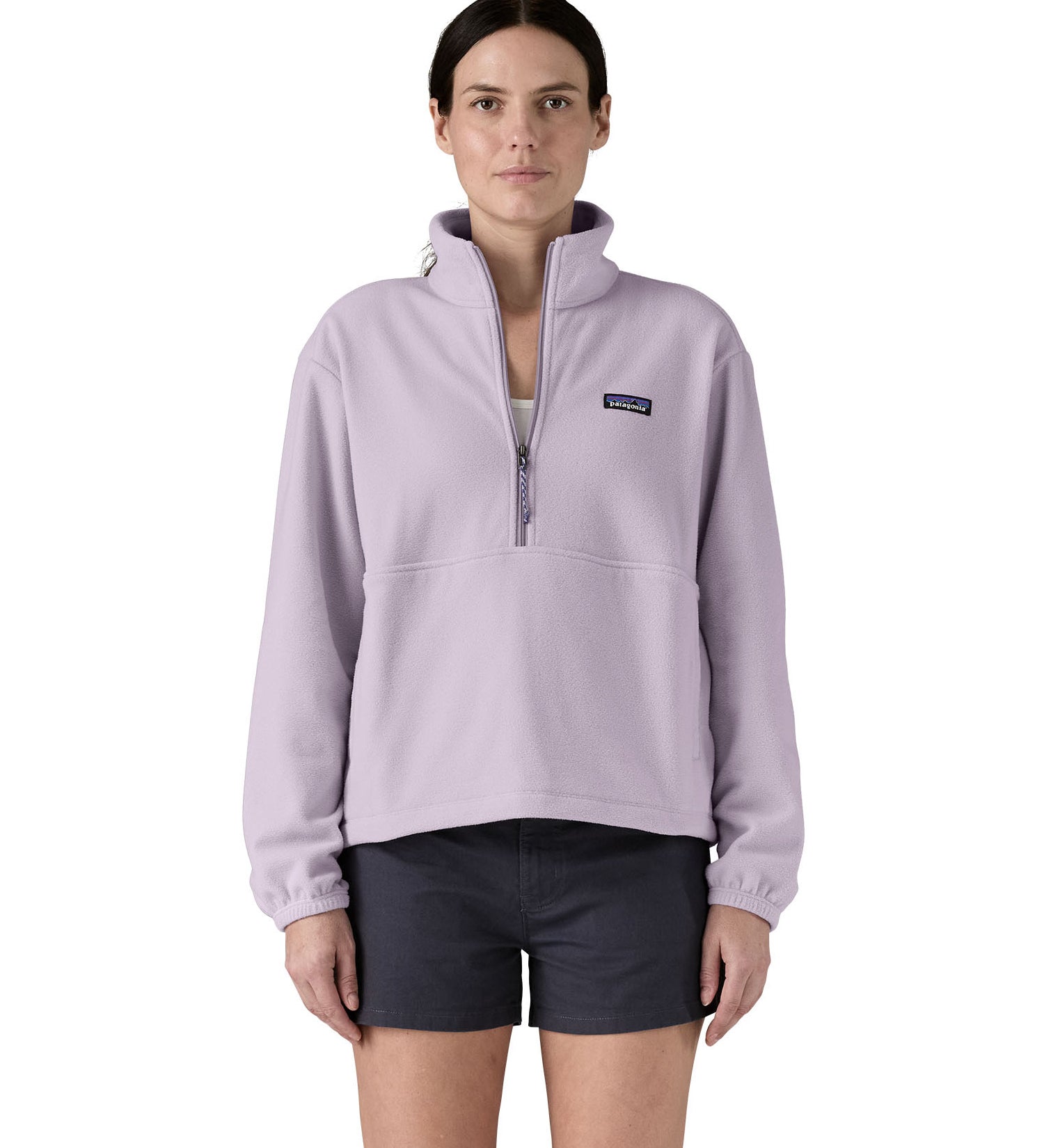 Patagonia women's micro 1/2 zip fleece in a light purple colour worn by a woman 