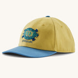 Patagonia kid's funhoggers hat in limestone yellow with island turtle embroidery detail on the front and a blue peak