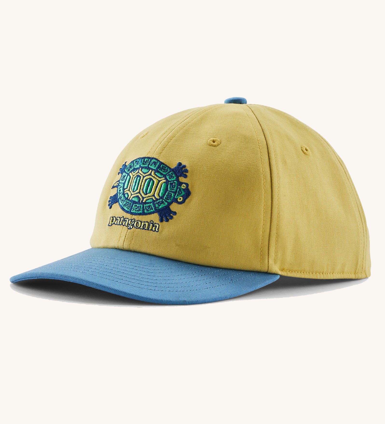 Patagonia kid's funhoggers hat in limestone yellow with island turtle embroidery detail on the front and a blue peak
