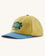 Patagonia kid's funhoggers hat in limestone yellow with island turtle embroidery detail on the front and a blue peak
