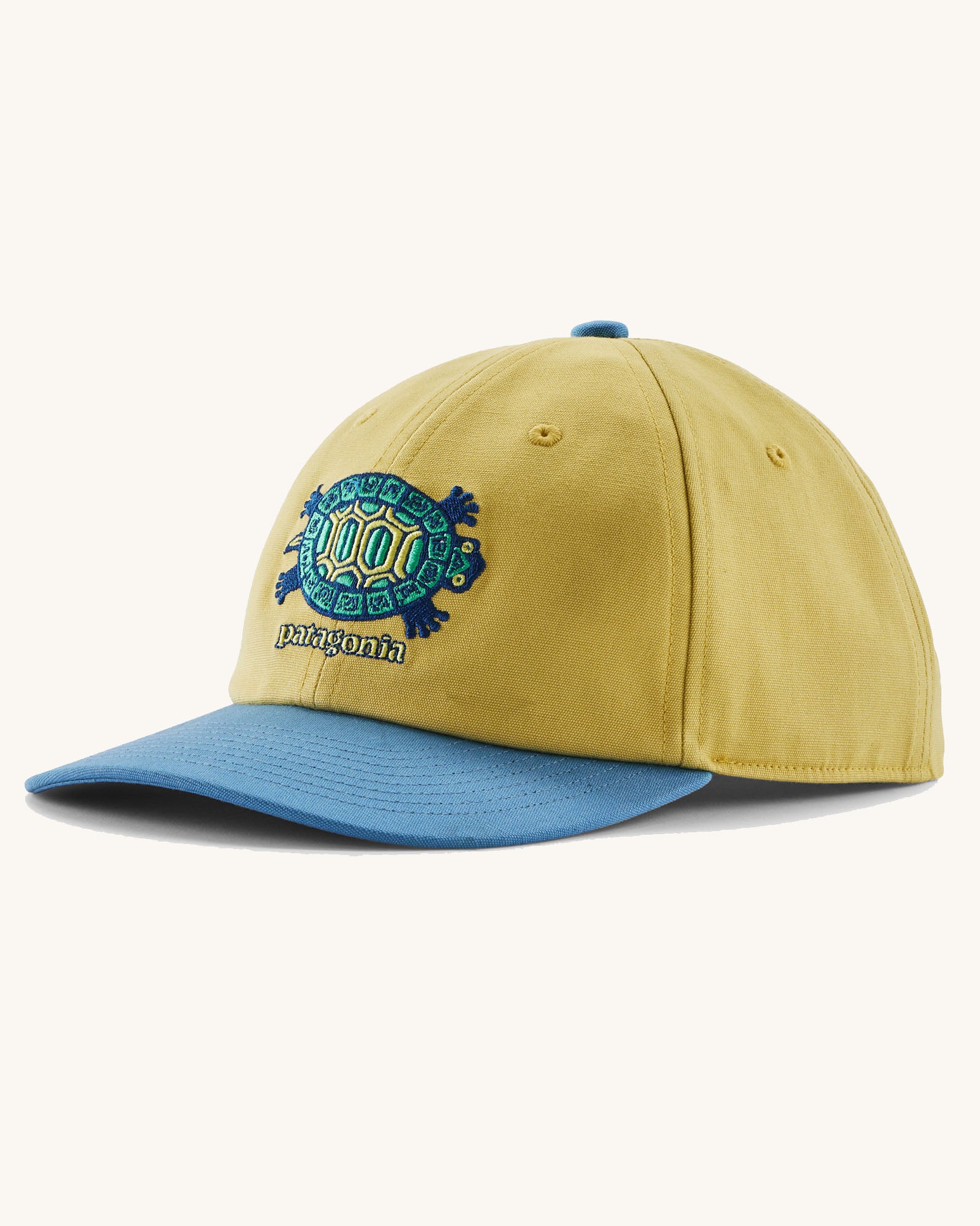 Patagonia kid's funhoggers hat in limestone yellow with island turtle embroidery detail on the front and a blue peak
