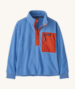 Patagonia kids half zip fleece in light blue colour on a cream background.
