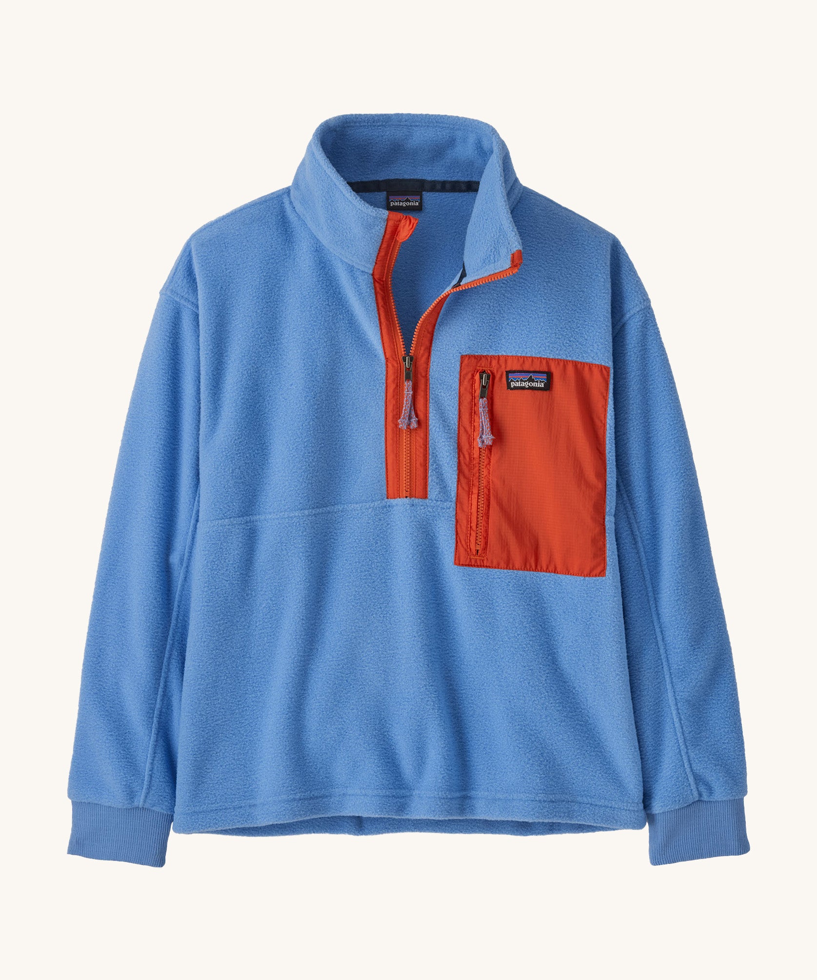Patagonia kids half zip fleece in light blue colour on a cream background.