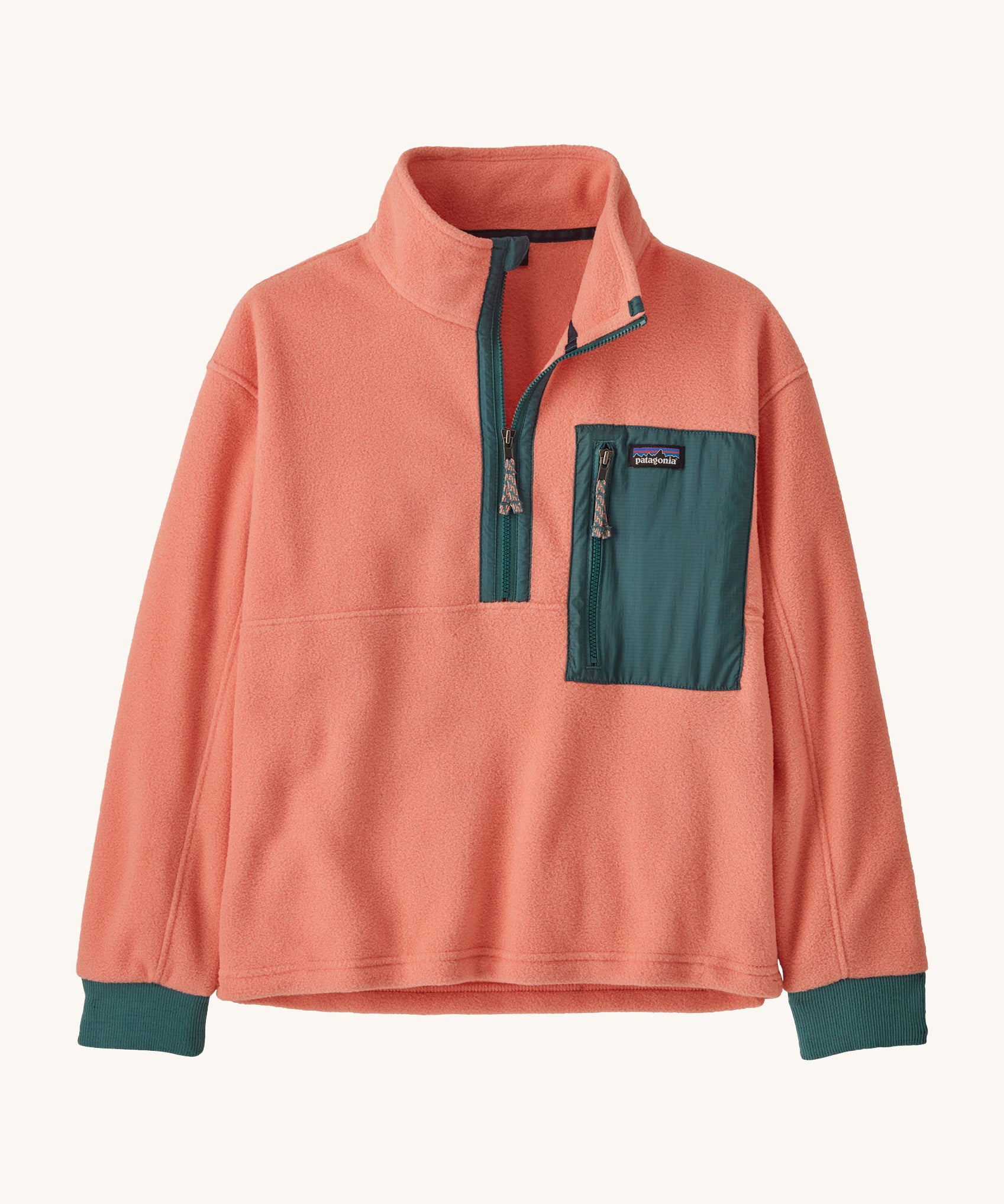 Patagonia kids half zip fleece in light pink colour on a cream background.