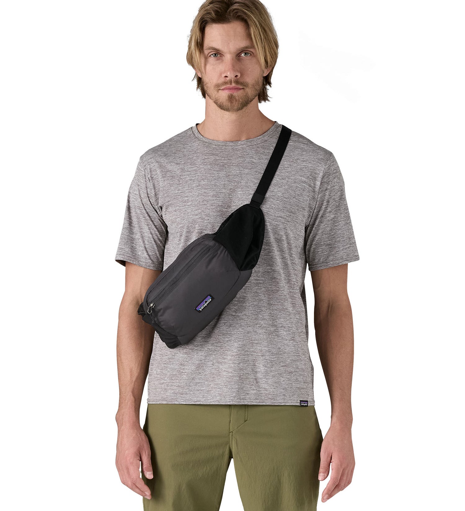 Patagonia terravia hip bag in a black colour worn by an adult on the shoulder