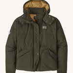 Patagonia downdrift jacket in pine green colour on a cream background.