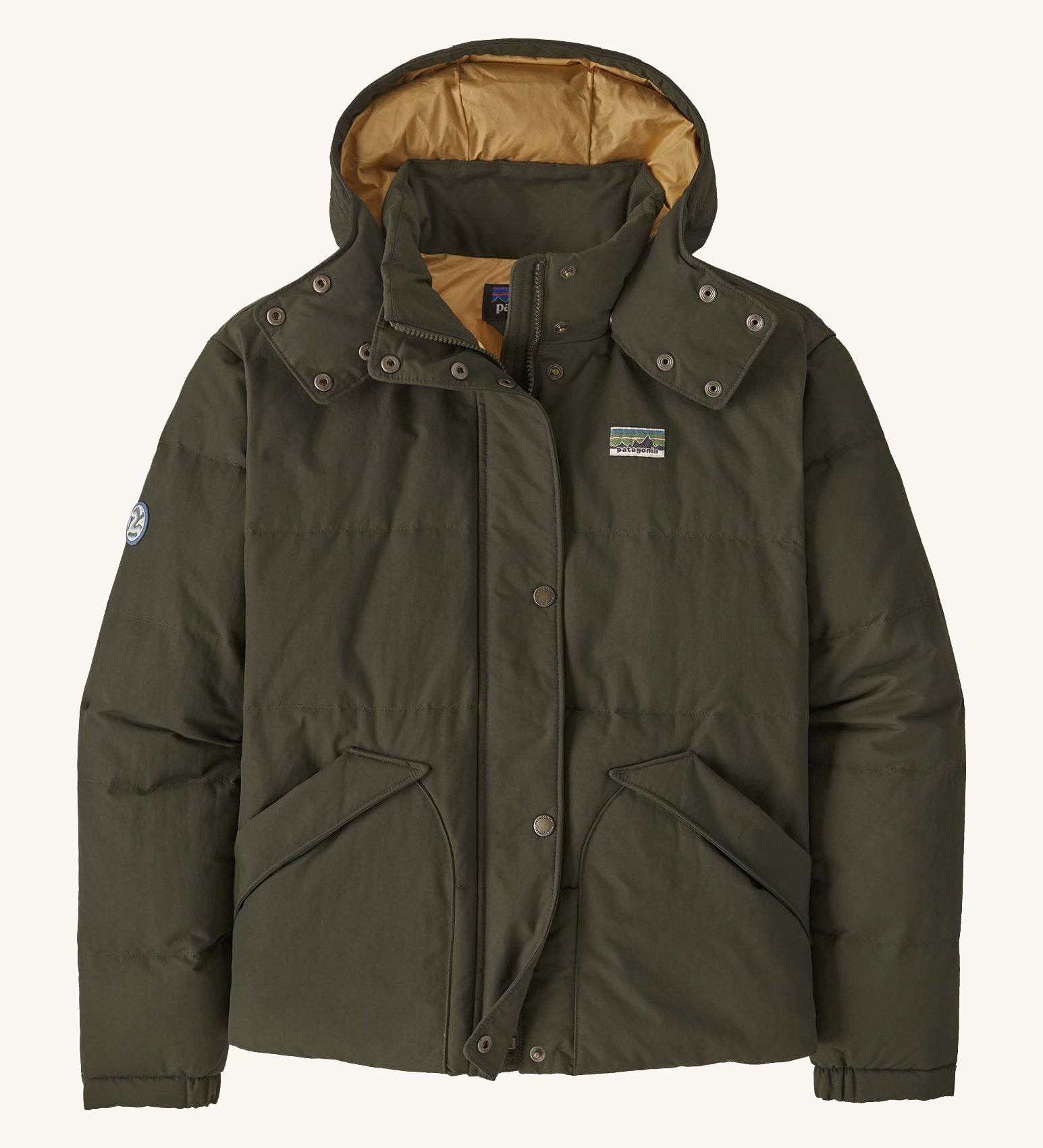 Patagonia downdrift jacket in pine green colour on a cream background.