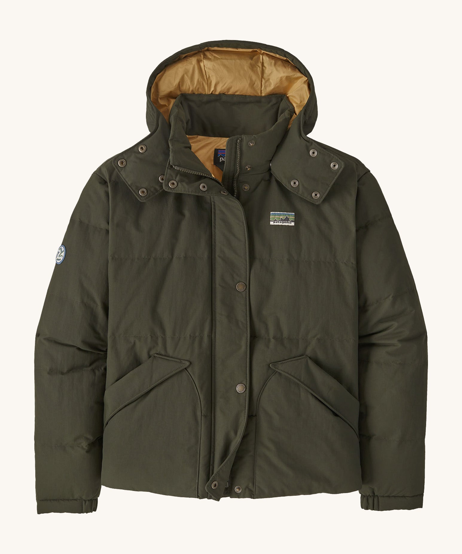 Patagonia downdrift jacket in pine green colour on a cream background.