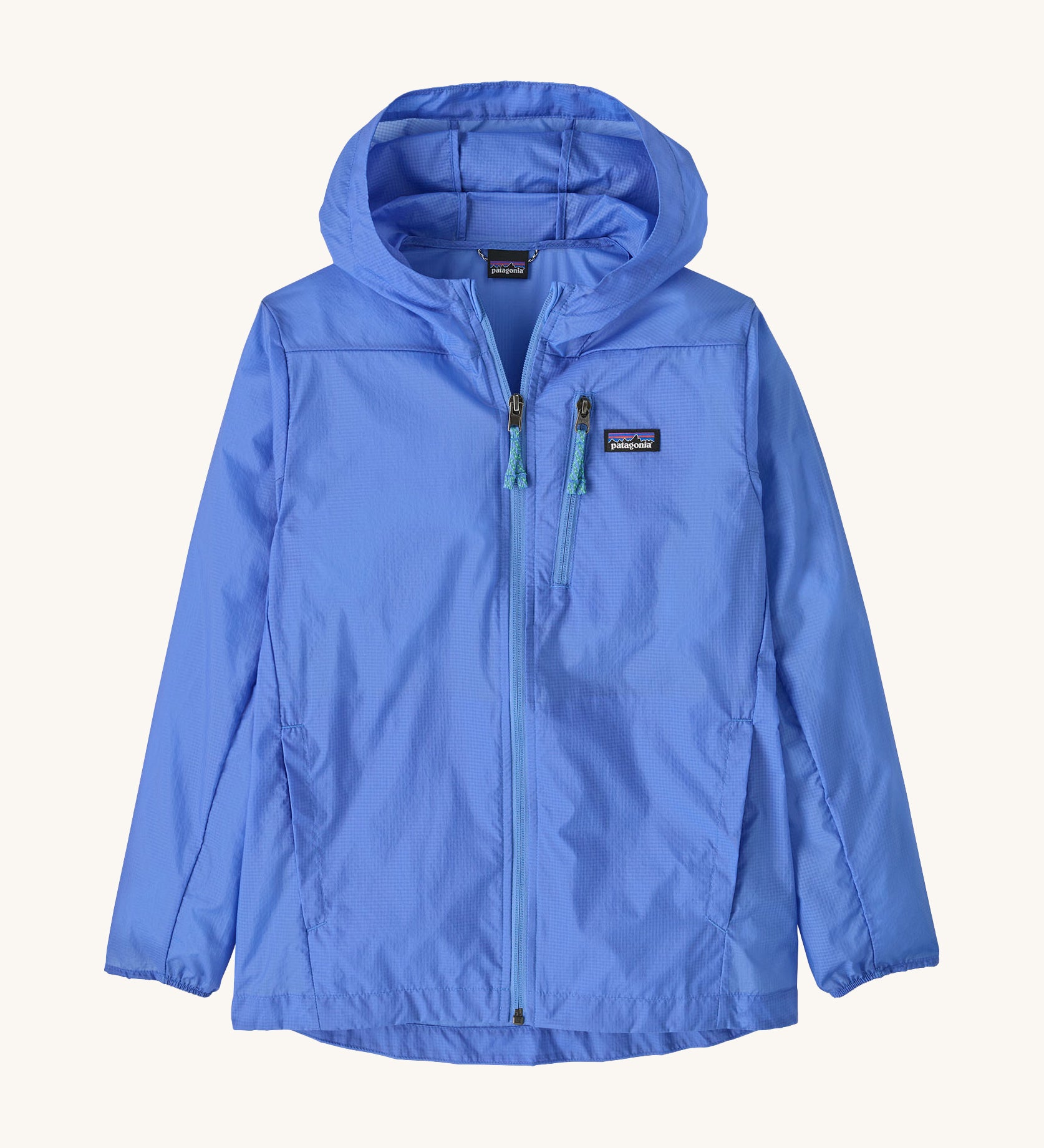 Patagonia light blue houdini zip up hooded jacket on a cream background