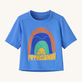 Patagonia kids blue short sleeve t-short rainbow design on a cream background.