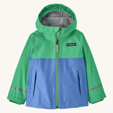 Patagonia kids torrentshell jacket in blue and green colour on a cream background.