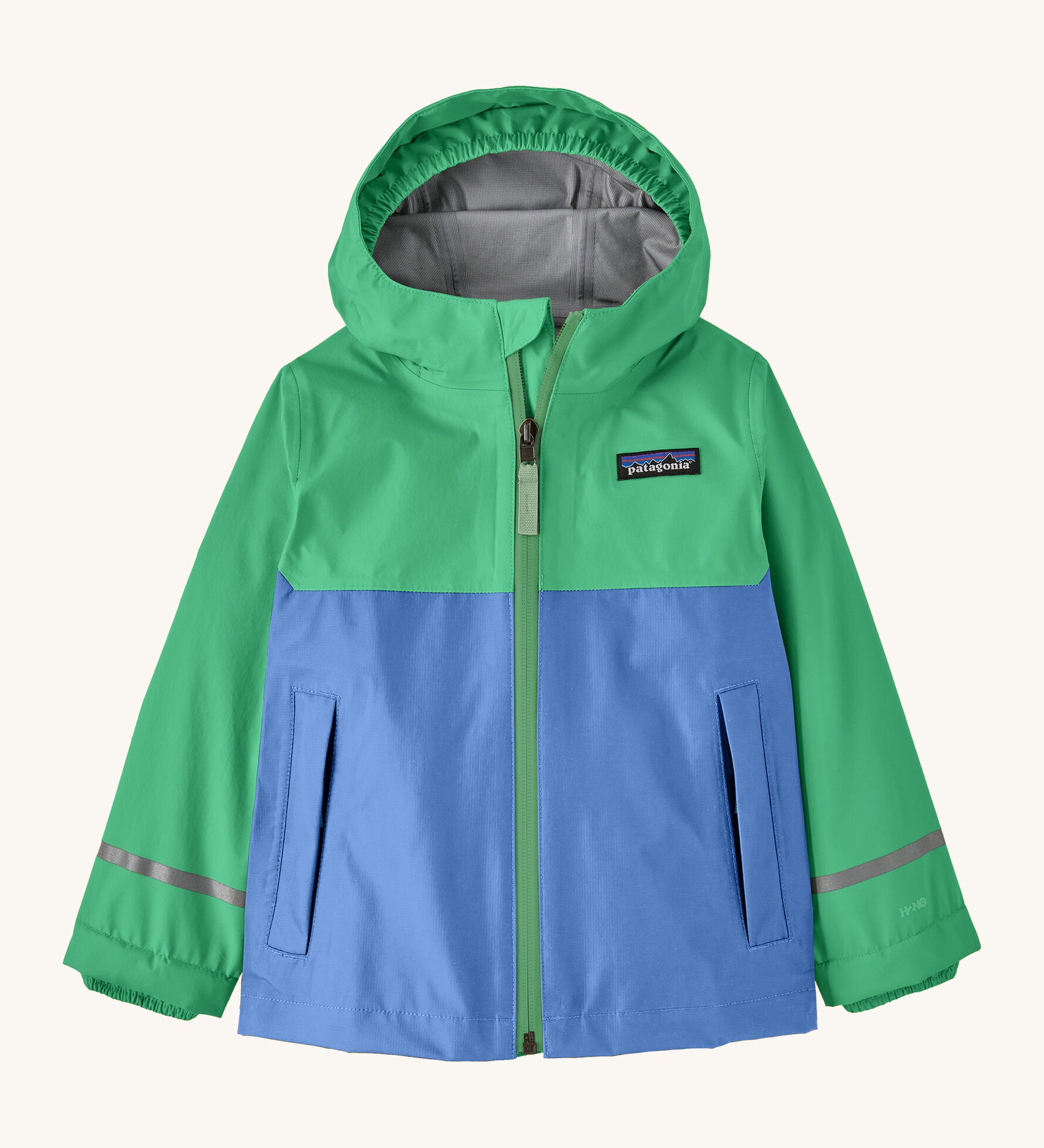 Patagonia kids torrentshell jacket in blue and green colour on a cream background.