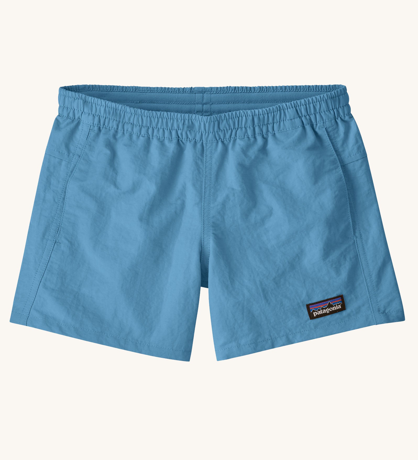 Patagonia kid's unlined baggies shorts in shore blue with small black logo label on the front. 