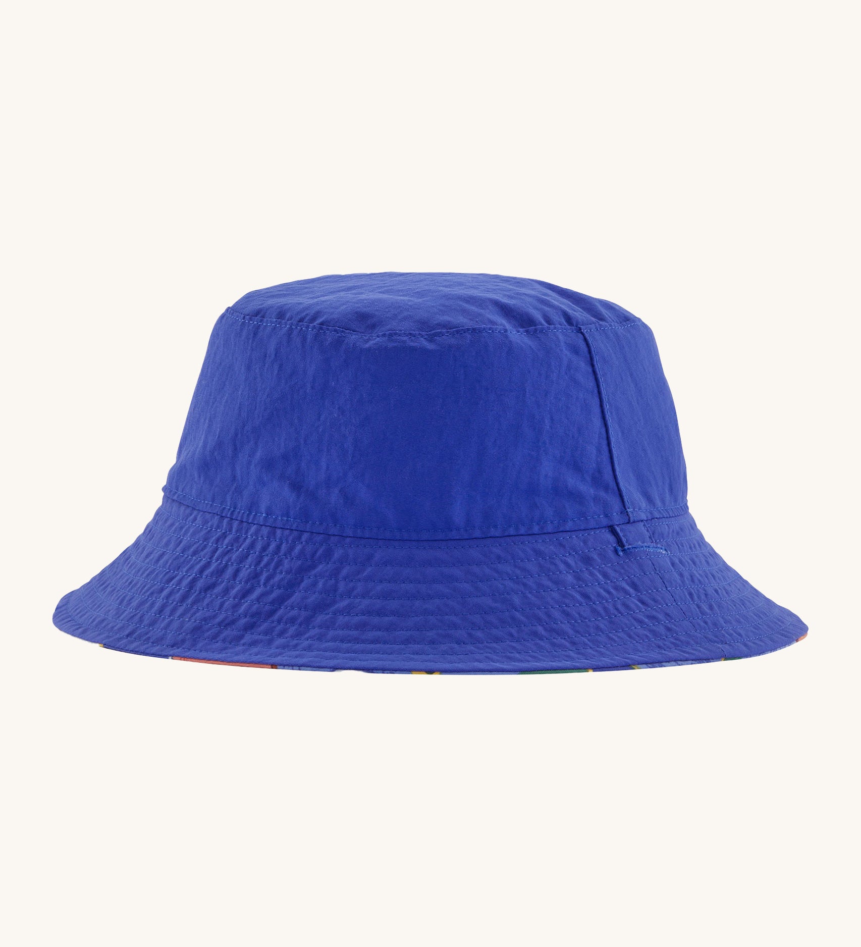 Patagonia kids bucket hat in blue colour on a cream background.