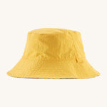 Patagonia kids bucket hat in a pastel yellow colour on a cream background.