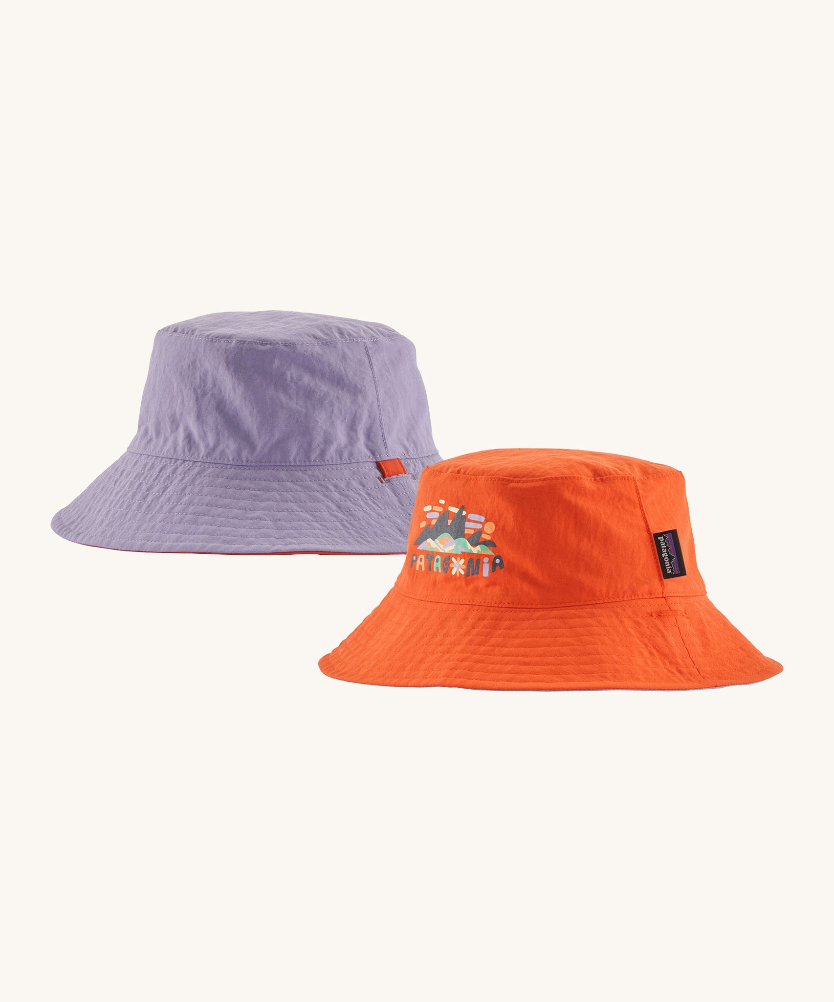Patagonia kids bucket hat in a pastel purple and orange colour on a cream background.