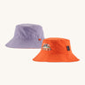 Patagonia kids bucket hat in a pastel purple and orange colour on a cream background.