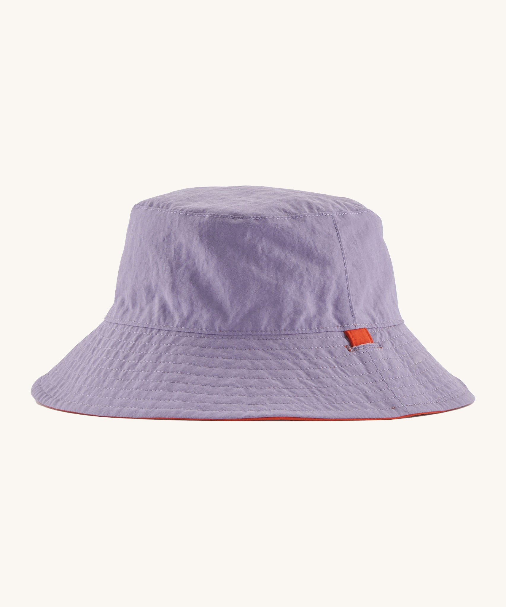 Patagonia kids bucket hat in a pastel purple colour on a cream background.