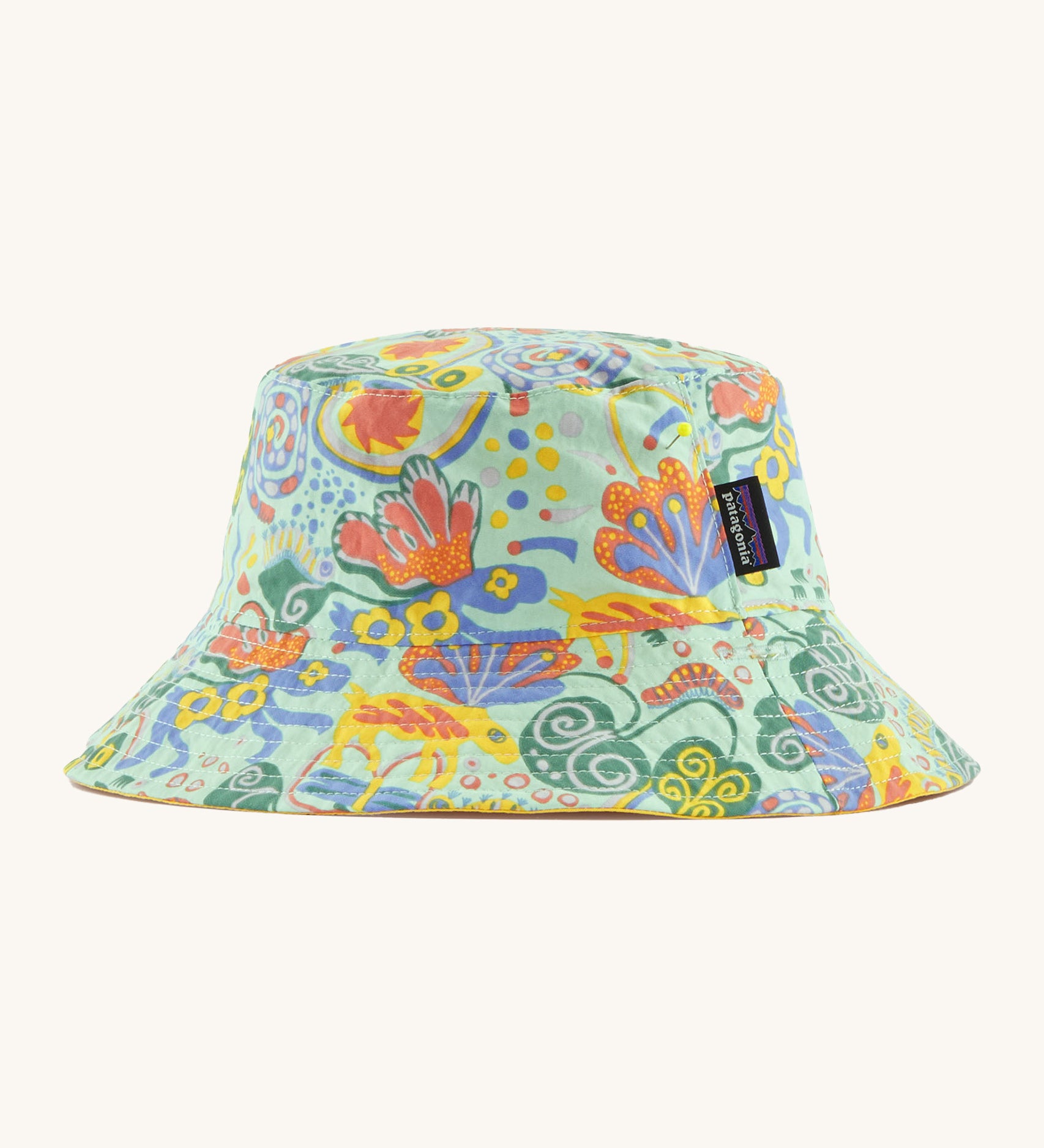 Patagonia kids bucket hat in a pastel green colour and multicoloured pattern design on a cream background.
