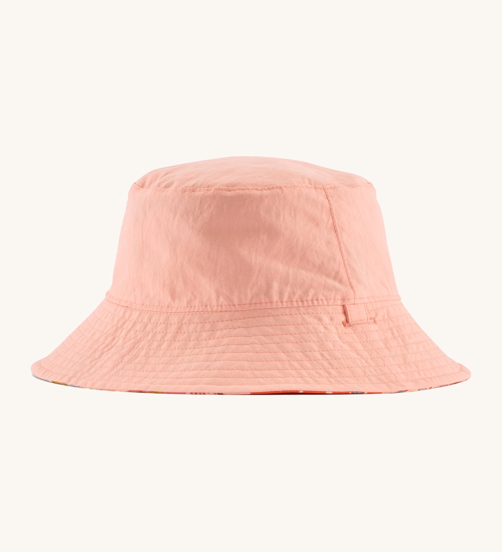 Patagonia kids bucket hat in pink colour on a cream background.