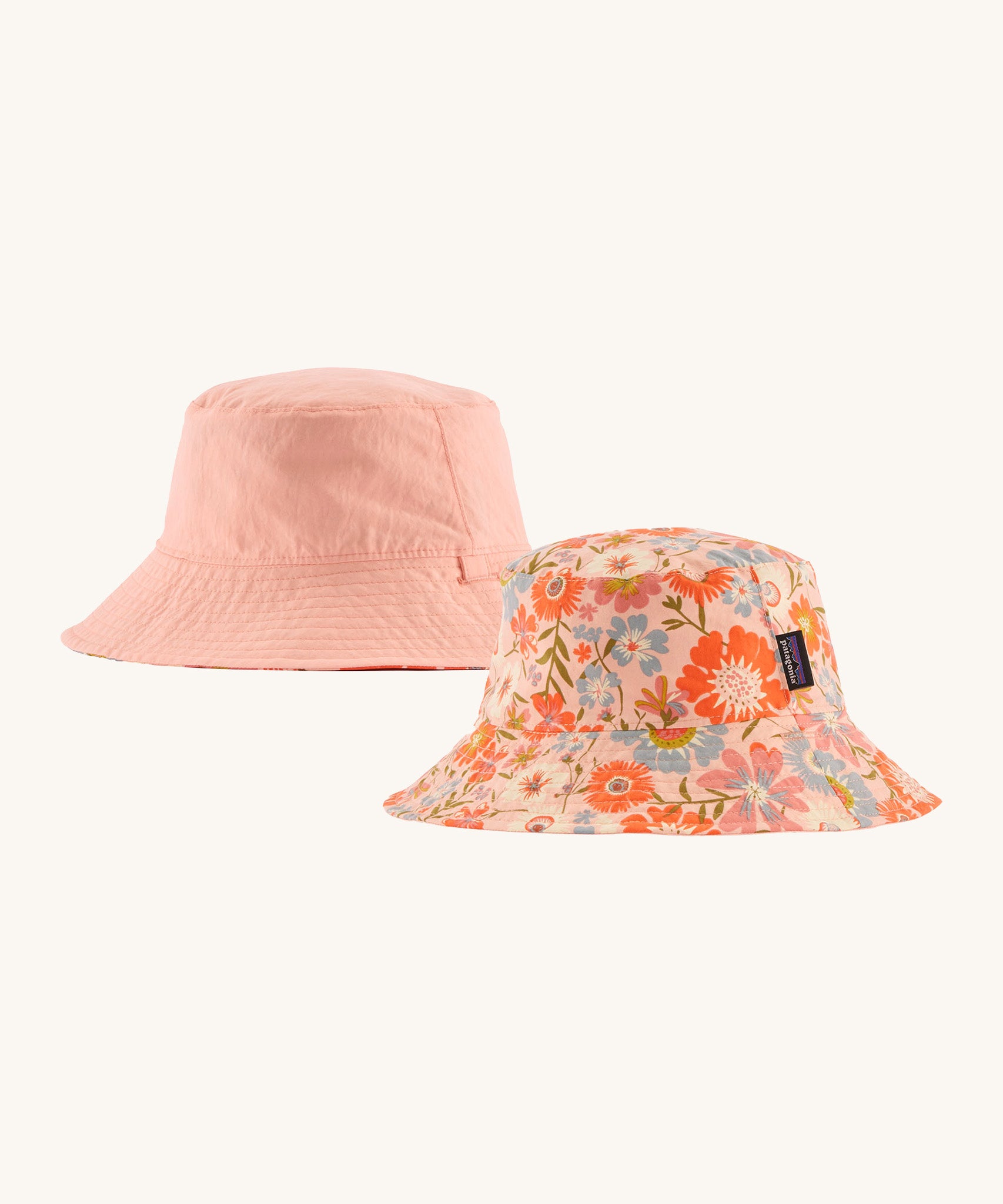 Patagonia kids bucket hat in multicoloured pink flower pattern design  and pink colour on a cream background.