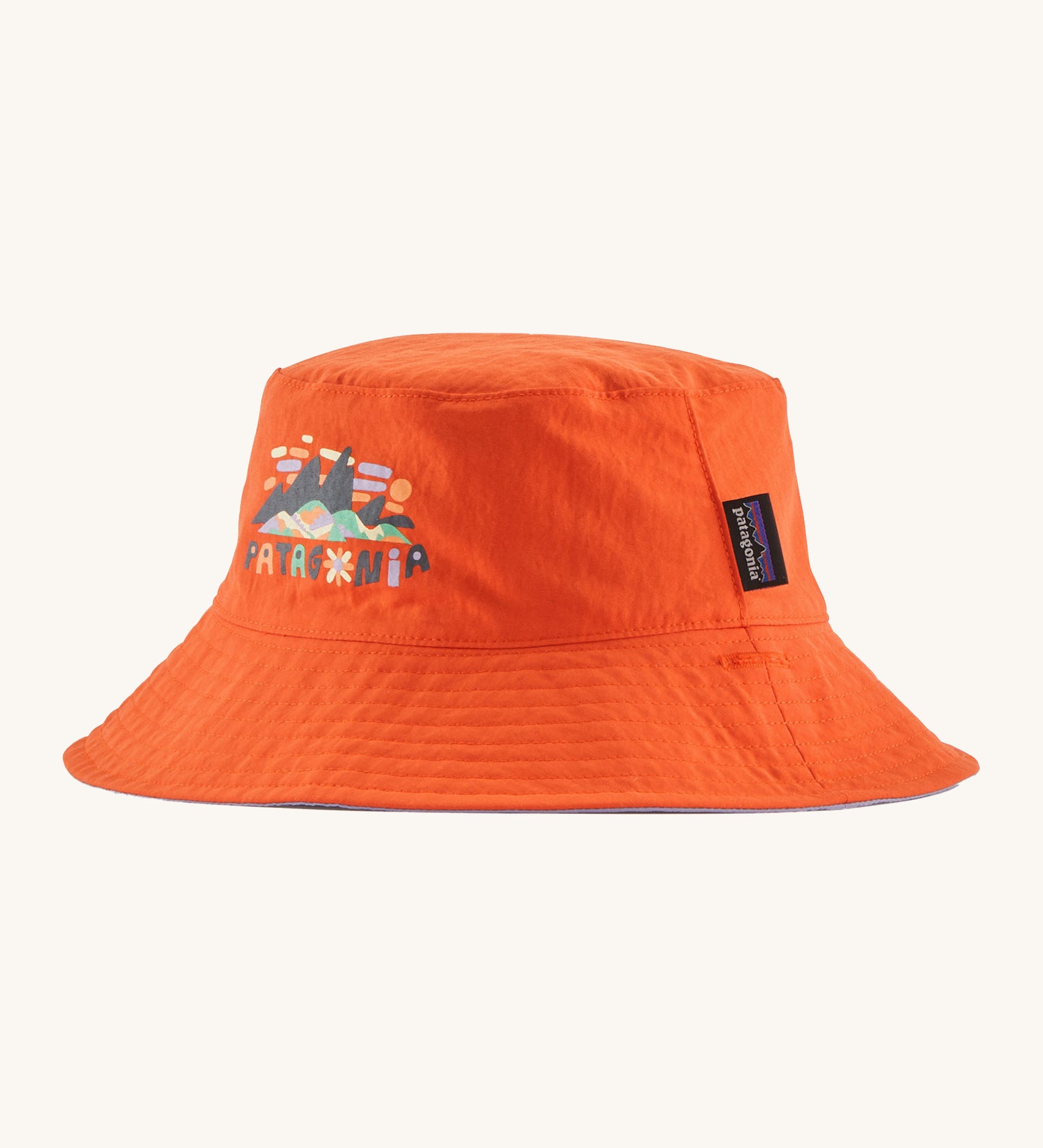 Patagonia kids bucket hat in a orange colour on a cream background.