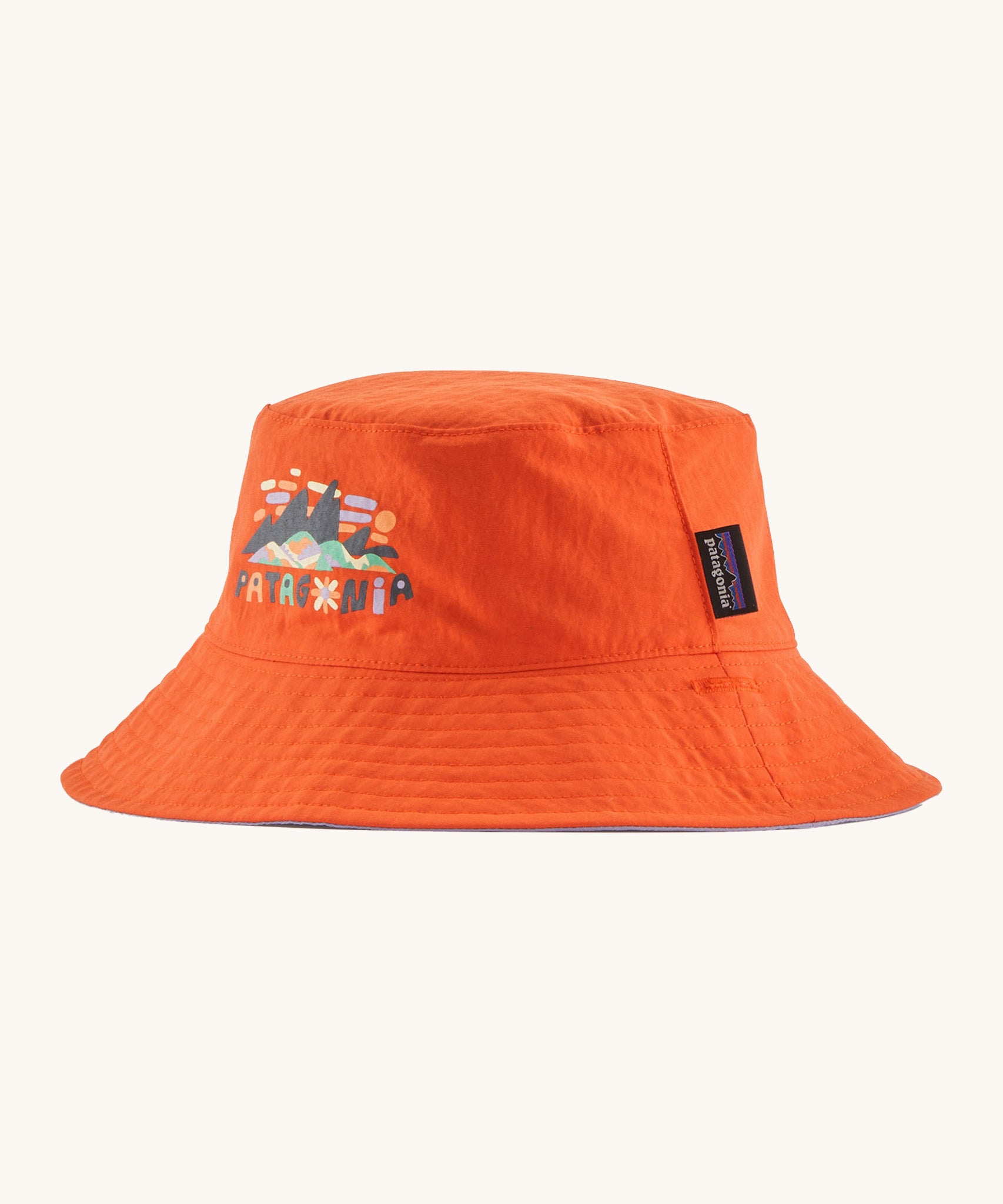 Patagonia kids bucket hat in a orange colour on a cream background.
