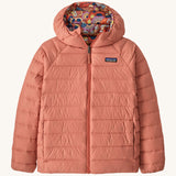 Patagonia Kids Reversible Down Hoody in river river and potters red design. A long sleeve jacket in pale pink featuring a full length zip and a colourful paisley design on the inside