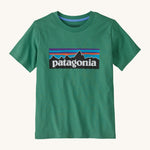 Patagonia kids short sleeve t-shirt in a dark green colour on a cream background