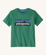 Patagonia kids short sleeve t-shirt in a dark green colour on a cream background