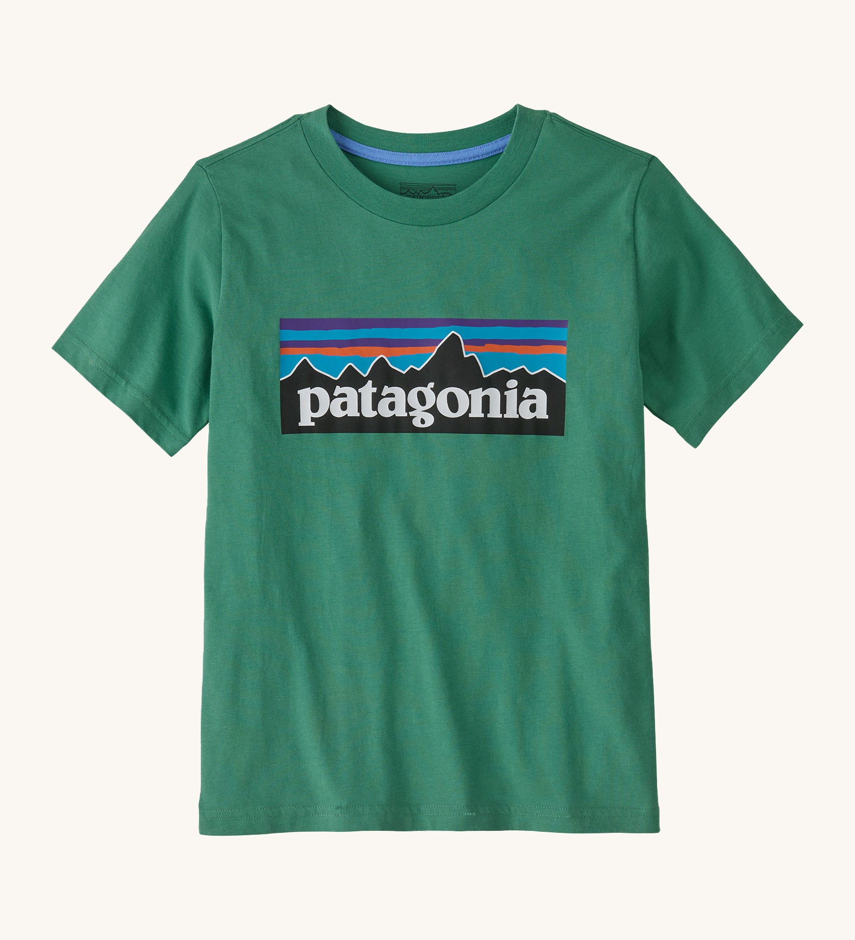 Patagonia kids short sleeve t-shirt in a dark green colour on a cream background