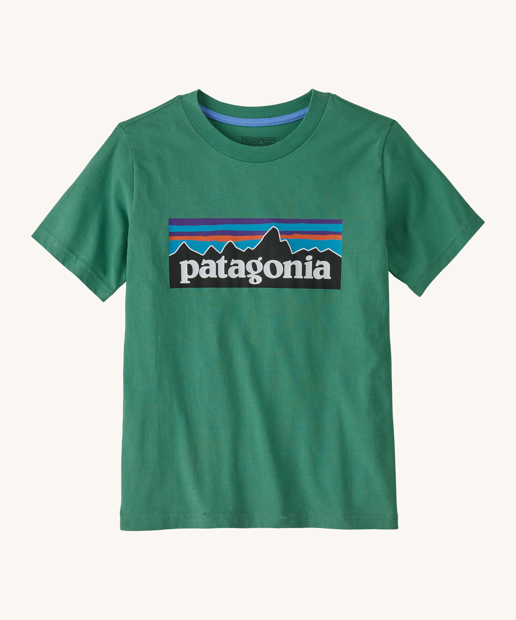 Patagonia kids short sleeve t-shirt in a dark green colour on a cream background