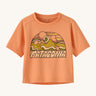 Patagonia kids light orange short sleeve t-short mountain design on a cream background.