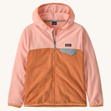 Patagonia kids hooded fleece in a light pink colour on a cream background.