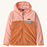 Patagonia kids hooded fleece in a light pink colour on a cream background.