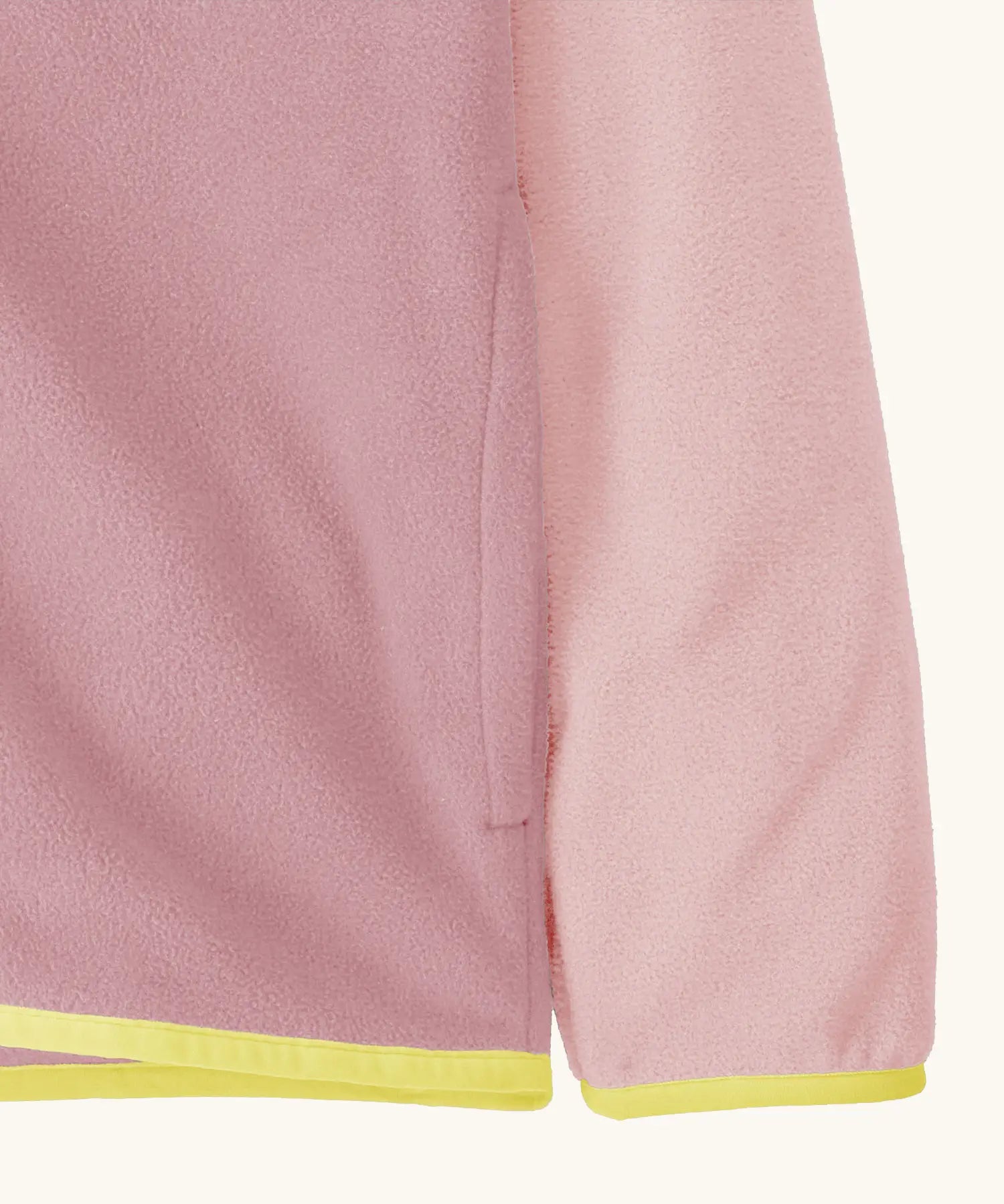 Close up of side pocket on Patagonia kid's micro-d snap-t hooded jacket in purple and pink showing light yellow trim on hem and cuff