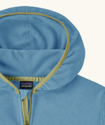 Close up of Patagonia kid's micro-d snap-t hooded jacket in blue showing dark yellow trim around the hood