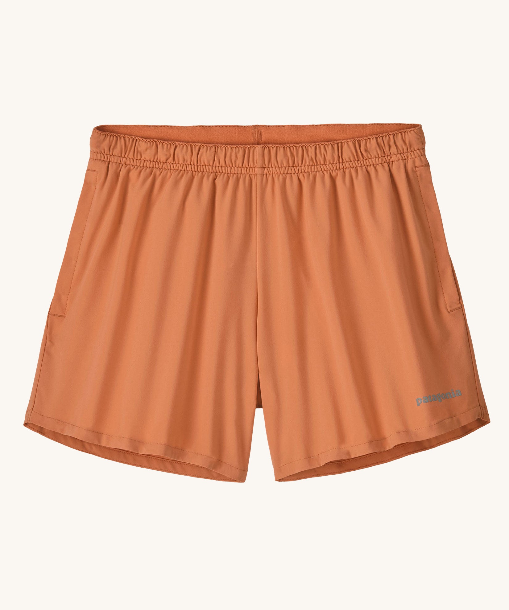 The Patagonia Kids Multi Trails Shorts 4 Inch in Rock Melon, technical sports shorts in peach pink with side seam pockets and a minimal elasticated waistband. Made from 90% OceanCycle recycled polyester.