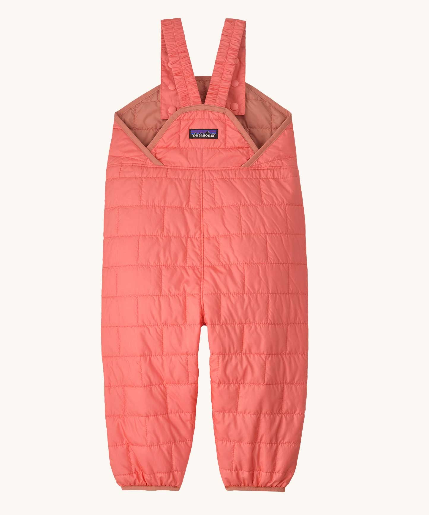 The back of the Patagonia kids nano puffer winter overalls in pink. Features popper fasteners on each shoulder strap for size adjustment. 