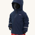 A child's size mannequin wearing the Patagonia Little Kids Torrentshell 3L Waterproof Jacket in a New Navy colour against a plain background.