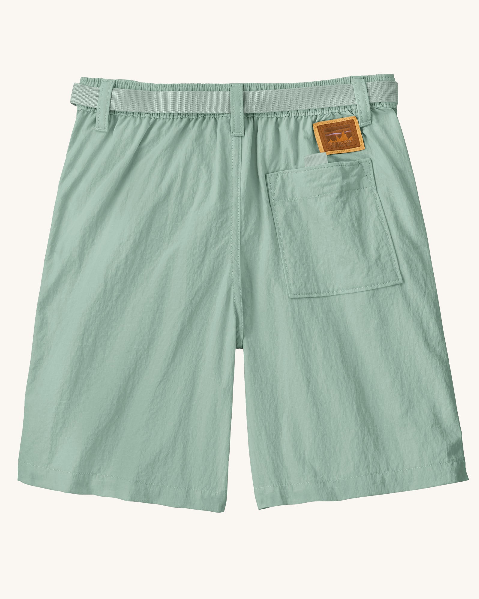Back of the Patagonia kid's outdoor everyday 6 inch shorts in thin ice light green with one back pocket and a brown logo badge.