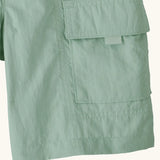 Close up of Patagonia kid's outdoor everyday 6 inch shorts in  light green showing side velcro pocket