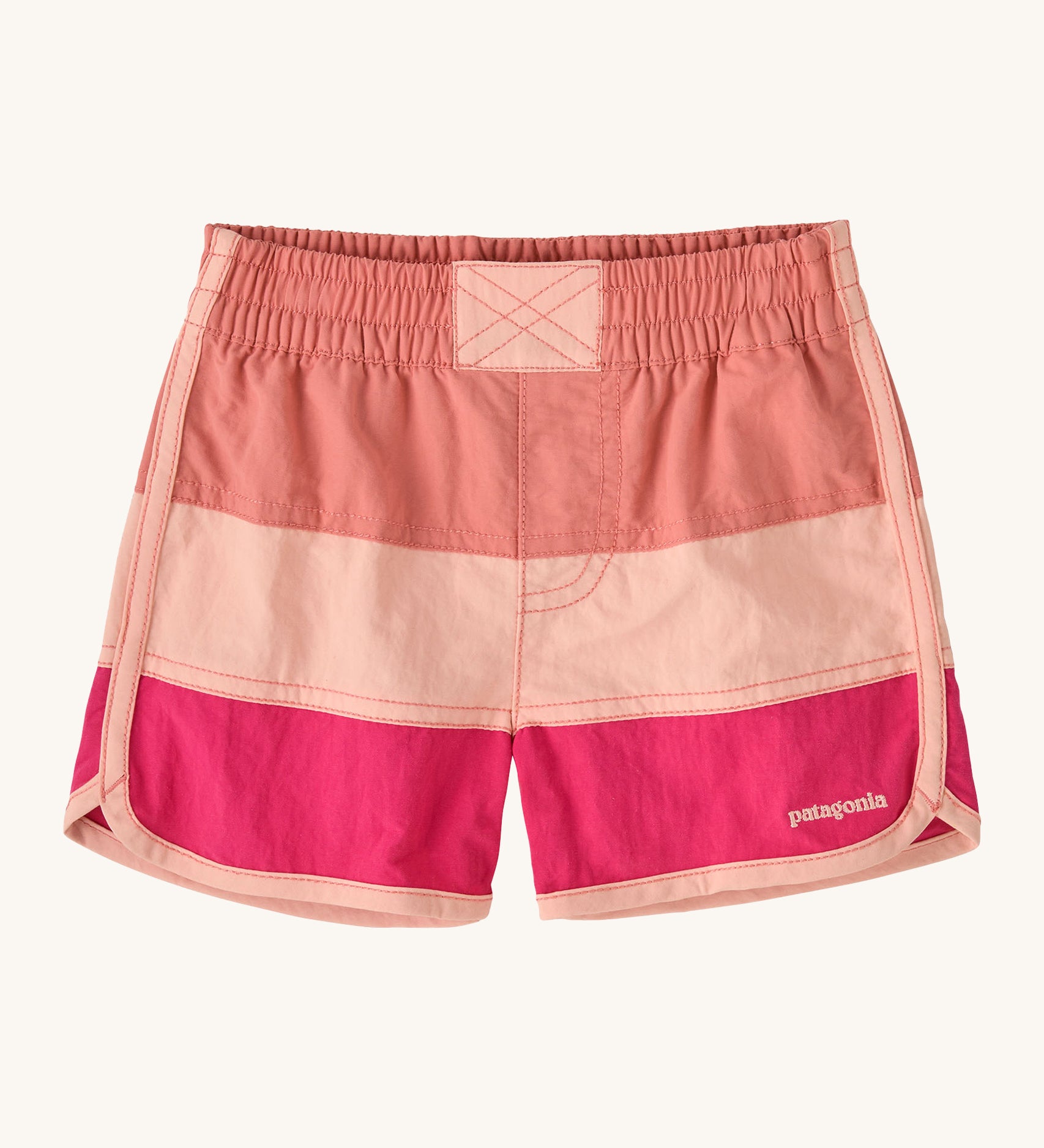 Patagonia kids swim shorts in pink colour block on a cream background