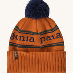 Patagonia Kids  Powder Town Beanie in an orange Redtail Rust colour on a plain background.