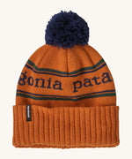 Patagonia Kids  Powder Town Beanie in an orange Redtail Rust colour on a plain background.
