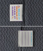 Close up of name tags on Patagonia high performance kids R1 air hoody in navy blue. 