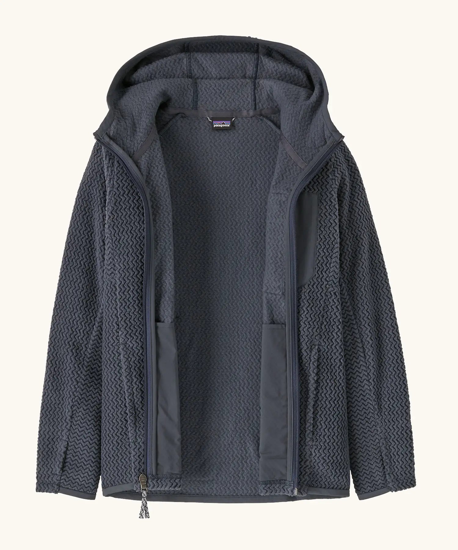 An open Patagonia high performance kids R1 air hoody in navy blue. 